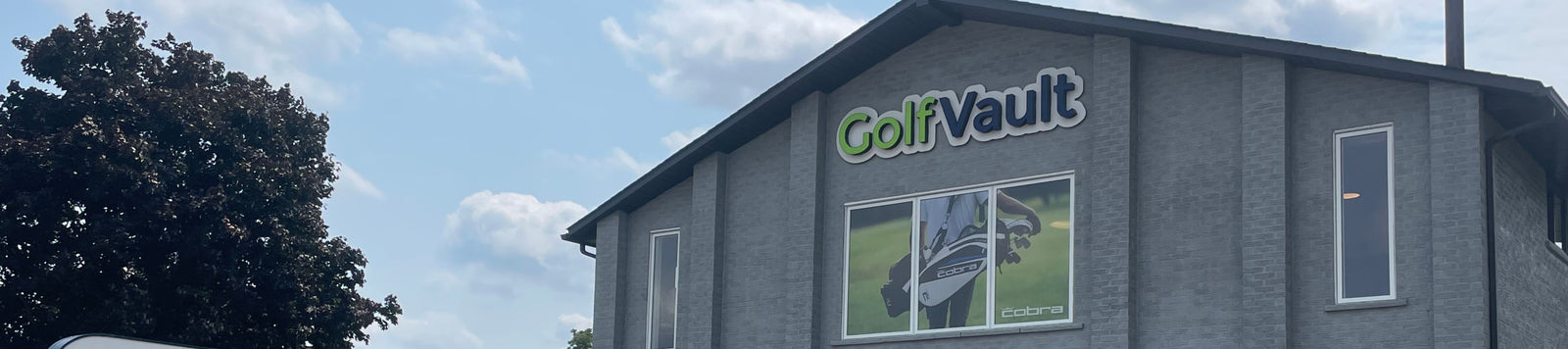 Golf vault physical store front building location with sign and photo of a golfer carrying a golf bag